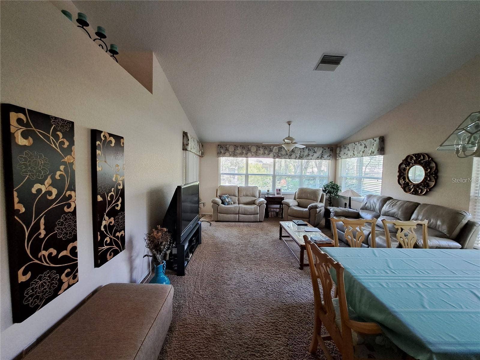 5316 LOCHMEAD TERRACE, Zephyrhills, FL 33541 Large living room with all hurricane protected new windows and sliding door to screened porch