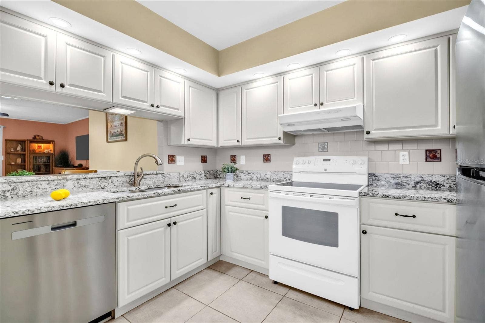 Granite countertops, solid-wood cabinetry, and recessed lighting~