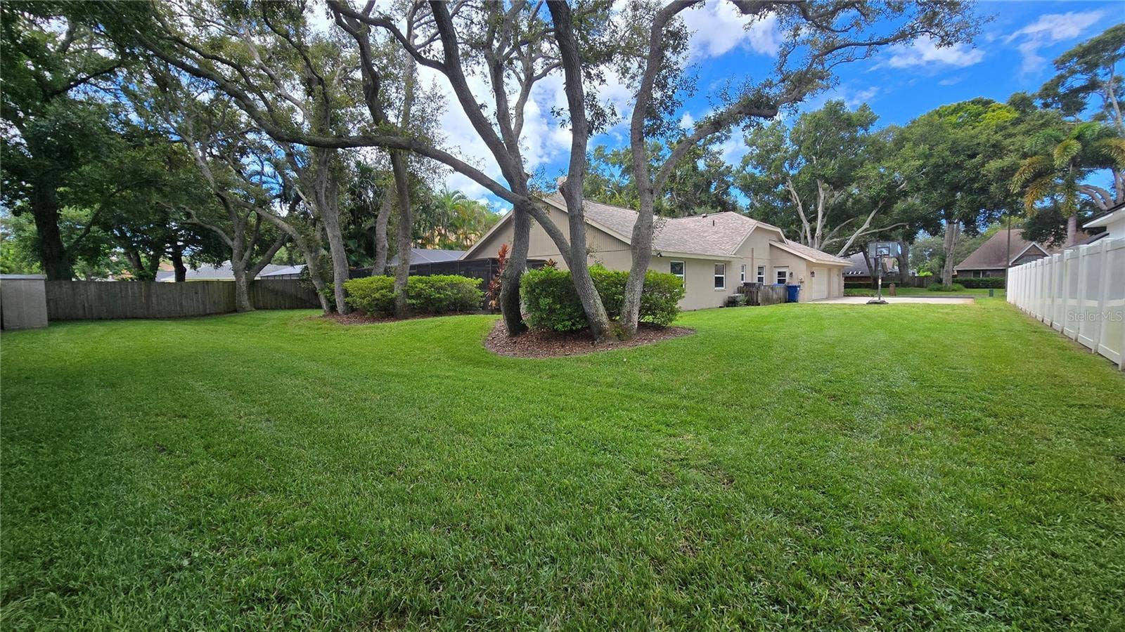 9991 WINDTREE BOULEVARD, Seminole, FL 33772 Huge lot with 0.39 acres with plenty of shade trees and a well groomed yard.
