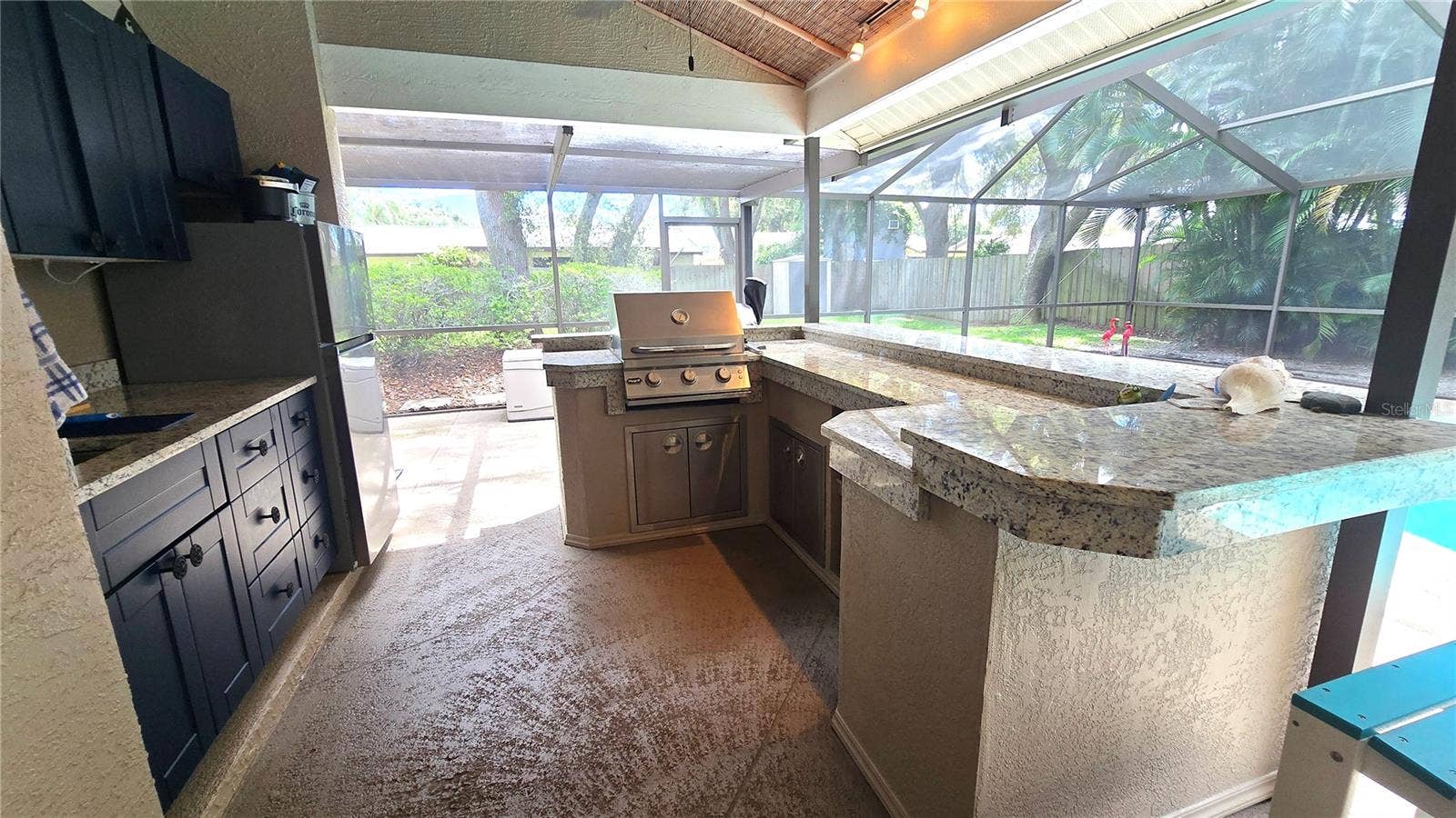 9991 WINDTREE BOULEVARD, Seminole, FL 33772 Like to party? Host all the parties here with this outdoor kitchen area with a built in bar-b-que, cabinets and sit up bar area.
