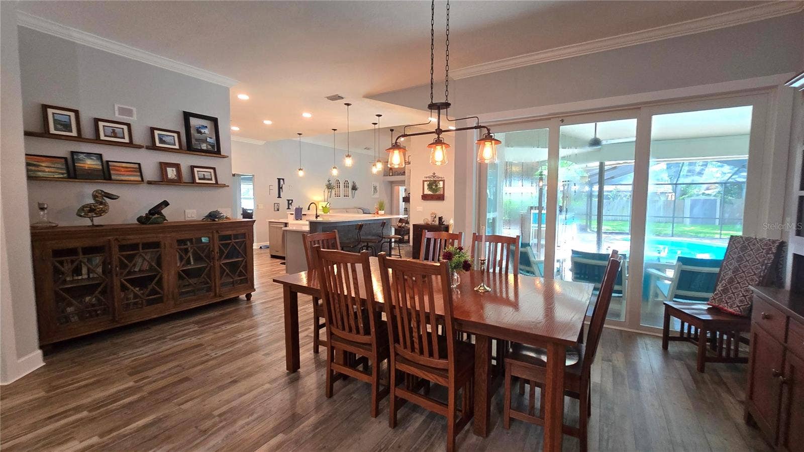 9991 WINDTREE BOULEVARD, Seminole, FL 33772 Lovely view from the dining room to the inviting pool area through the sliding glass doors.