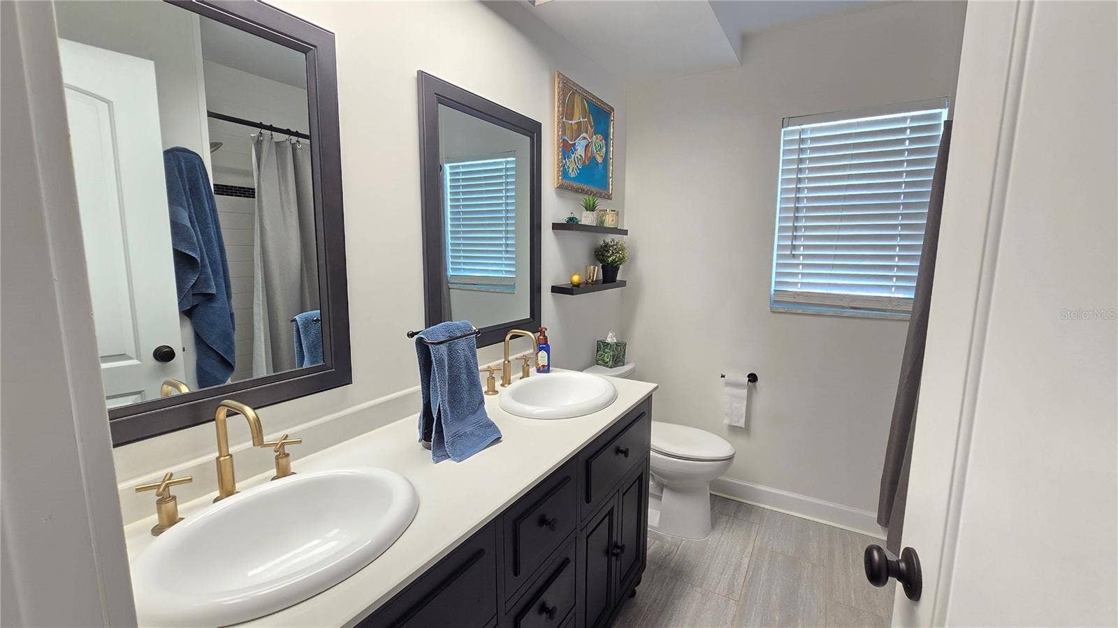 9991 WINDTREE BOULEVARD, Seminole, FL 33772 Full bathroom with shower/tub combo plus double sinks.