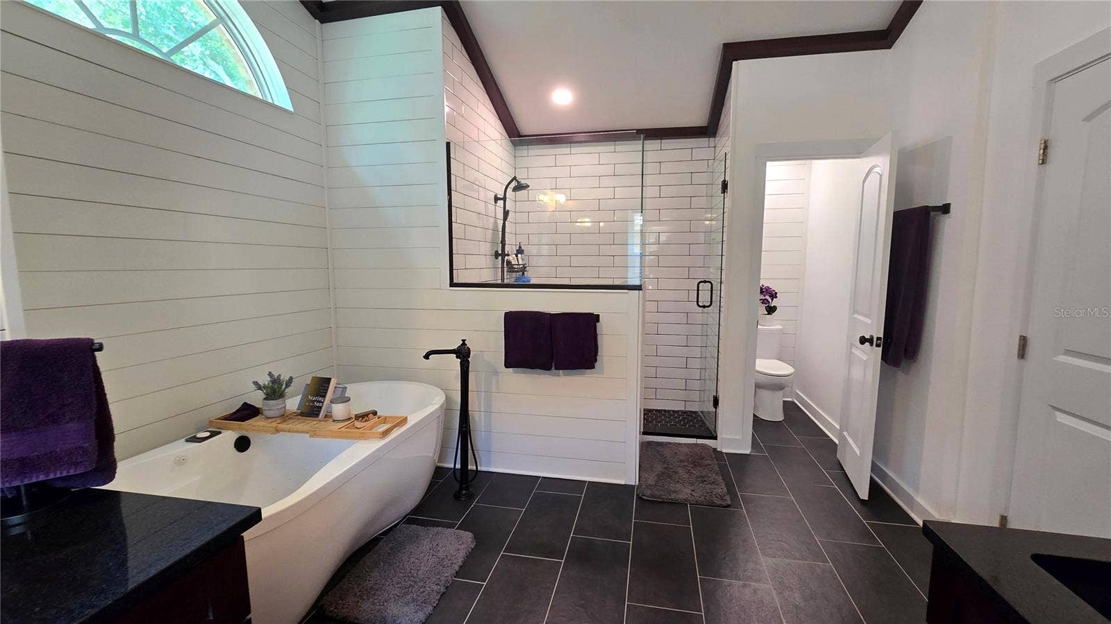 9991 WINDTREE BOULEVARD, Seminole, FL 33772 This Primary Bathroom is so large that it not only has a separate tub it also has a huge walk in shower as well as a separate room for privacy while in the bathroom.