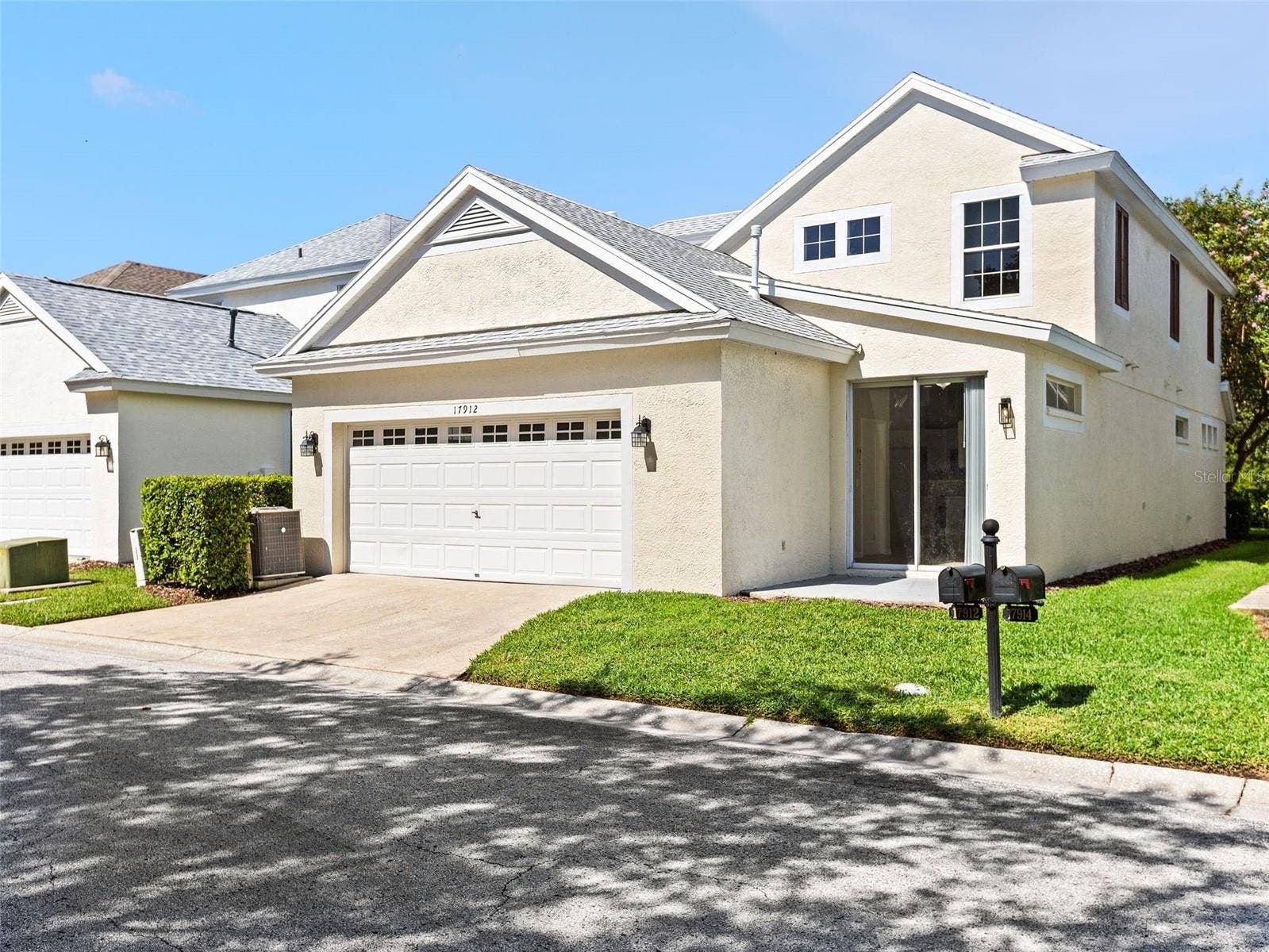 17912 HAVENVIEW LANE, Lutz, FL 33558 Back garage and sliding glass entrance