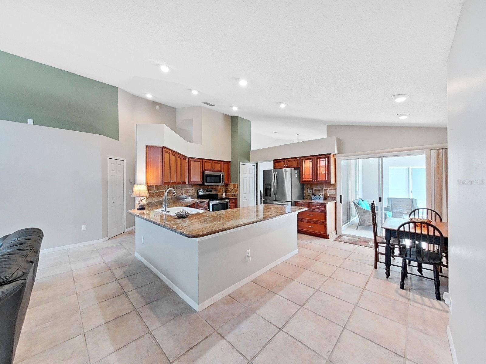 15001 MEADOWLAKE STREET, Odessa, FL 33556 updated kitchen with granite countertops, stainless appliances, recessed lighting