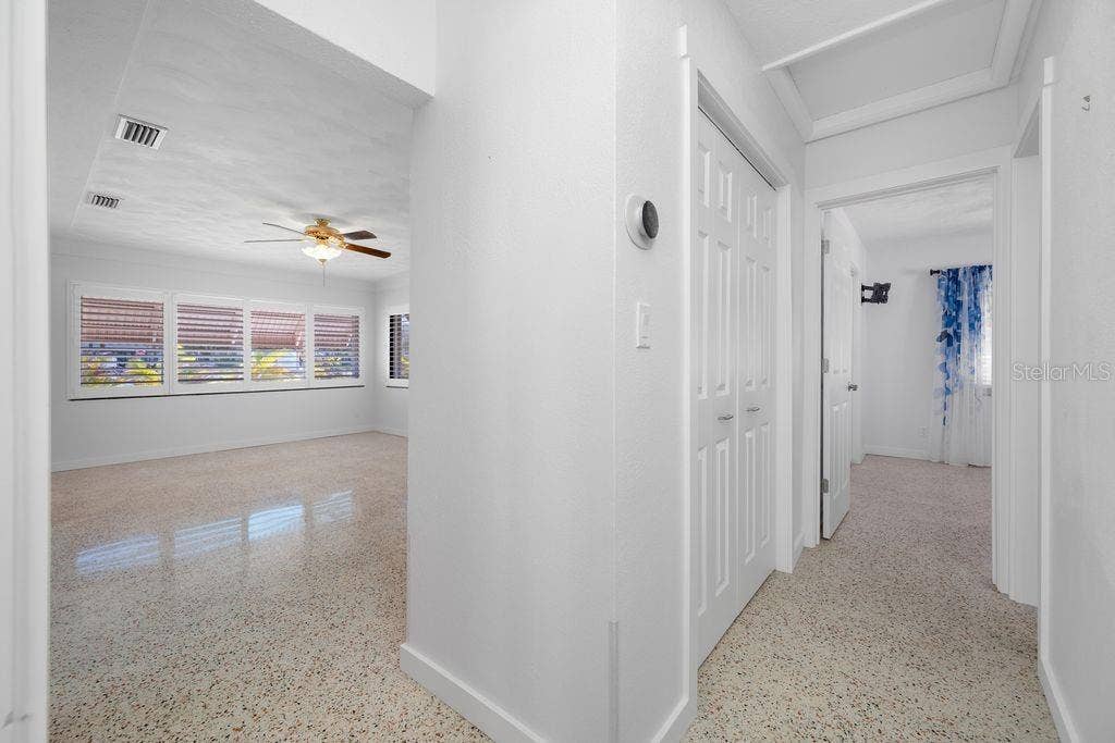 1472 DURLING DRIVE S, South Pasadena, FL 33707 Hallway from Primary Bedroom - Showing Living Room and Split Plan Guest Bedroom