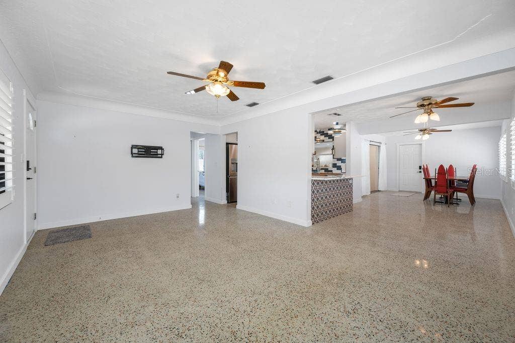 1472 DURLING DRIVE S, South Pasadena, FL 33707 Living Room View Into Hall and Primary Bedroom, Kitchen and Dining Room