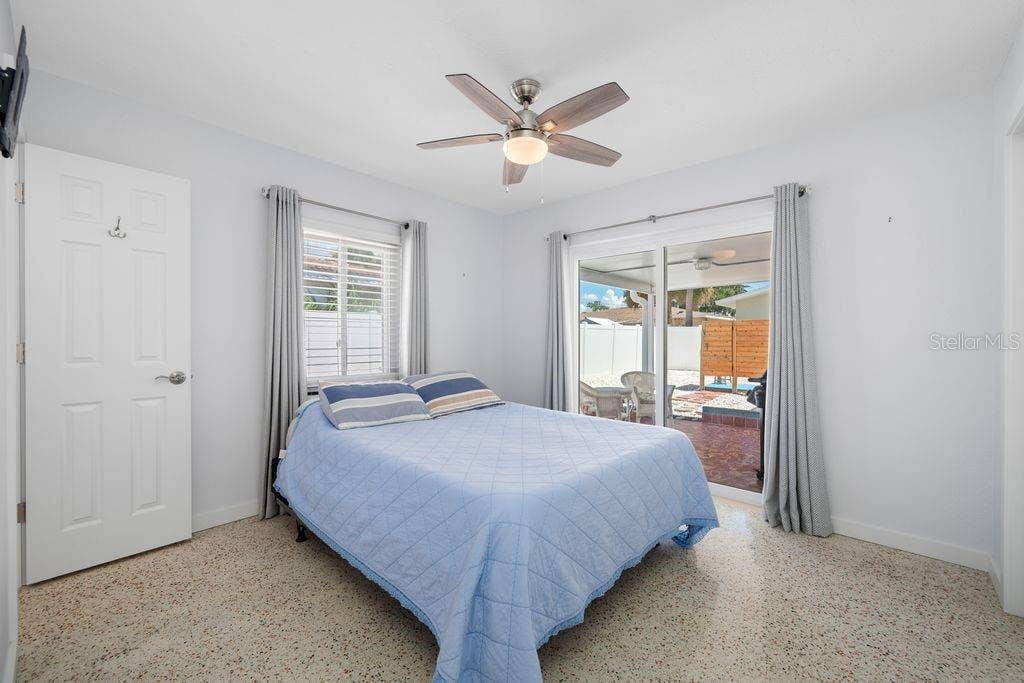1472 DURLING DRIVE S, South Pasadena, FL 33707 Primary Bedroom with En-Suite Bathroom to the Left and Sliding Glass Door access to Lanai