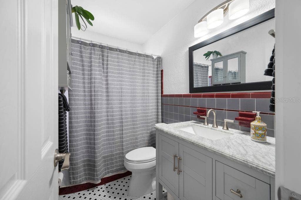1472 DURLING DRIVE S, South Pasadena, FL 33707 Retro Hall Bathroom with Updated Vanity, Mirror and Lighting