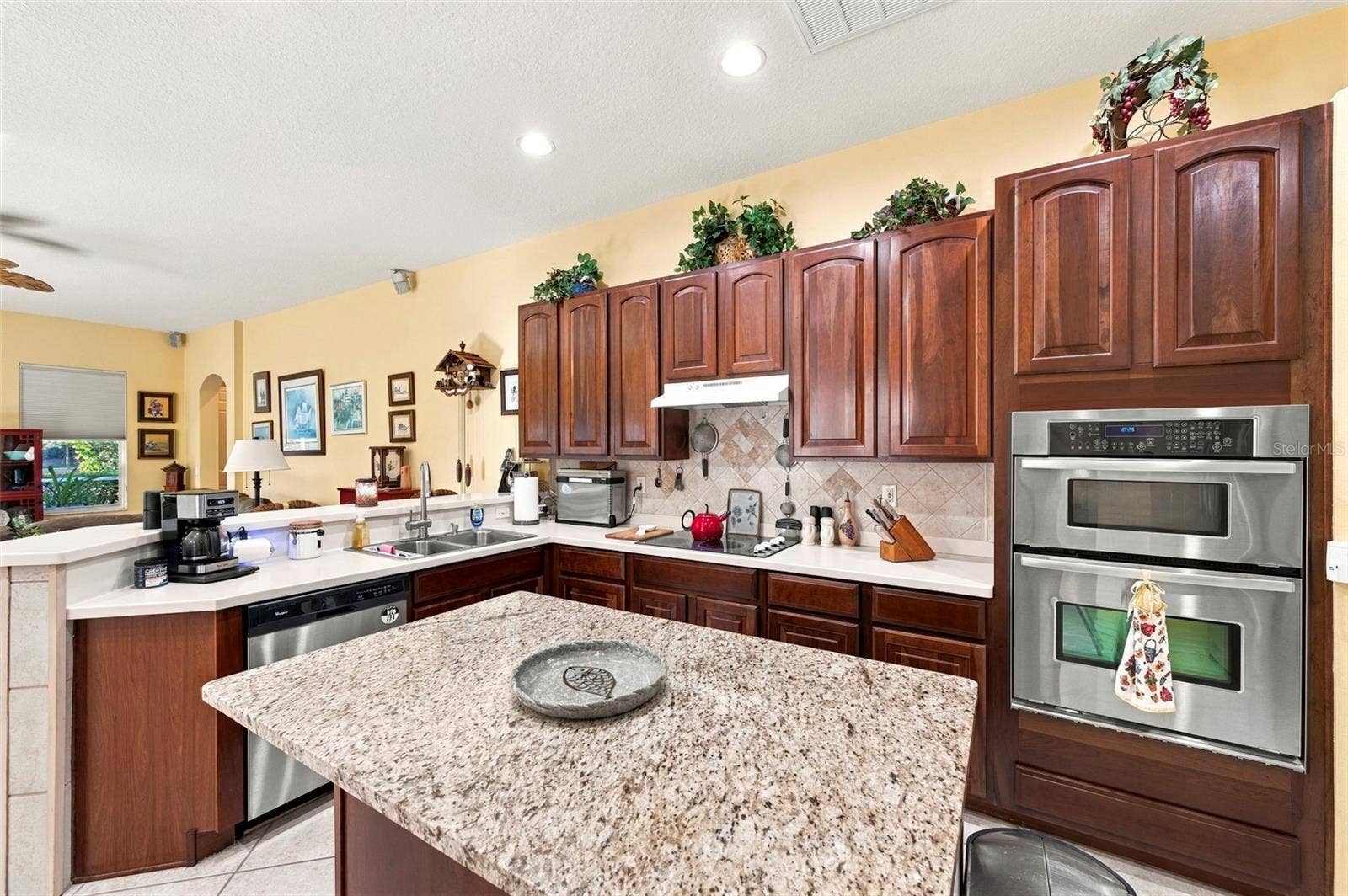 Open concept kitchen - stainless appliances with island