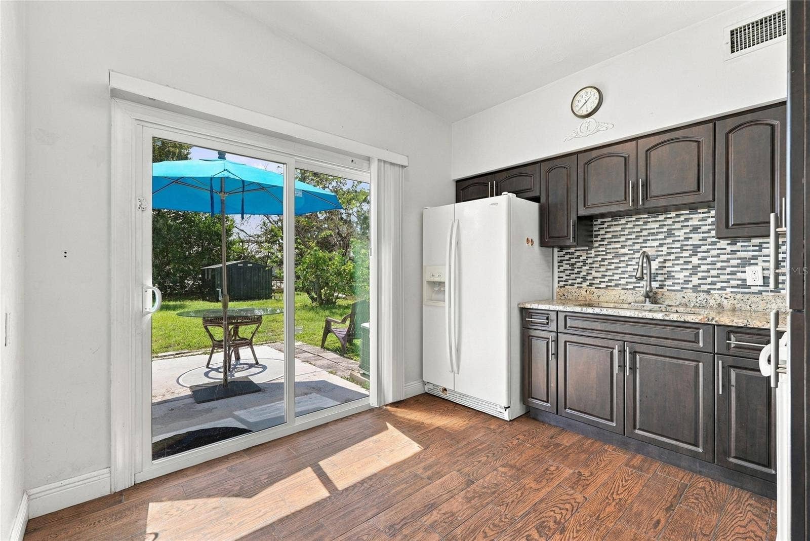 kitchen with new sliding glass door to large backyard