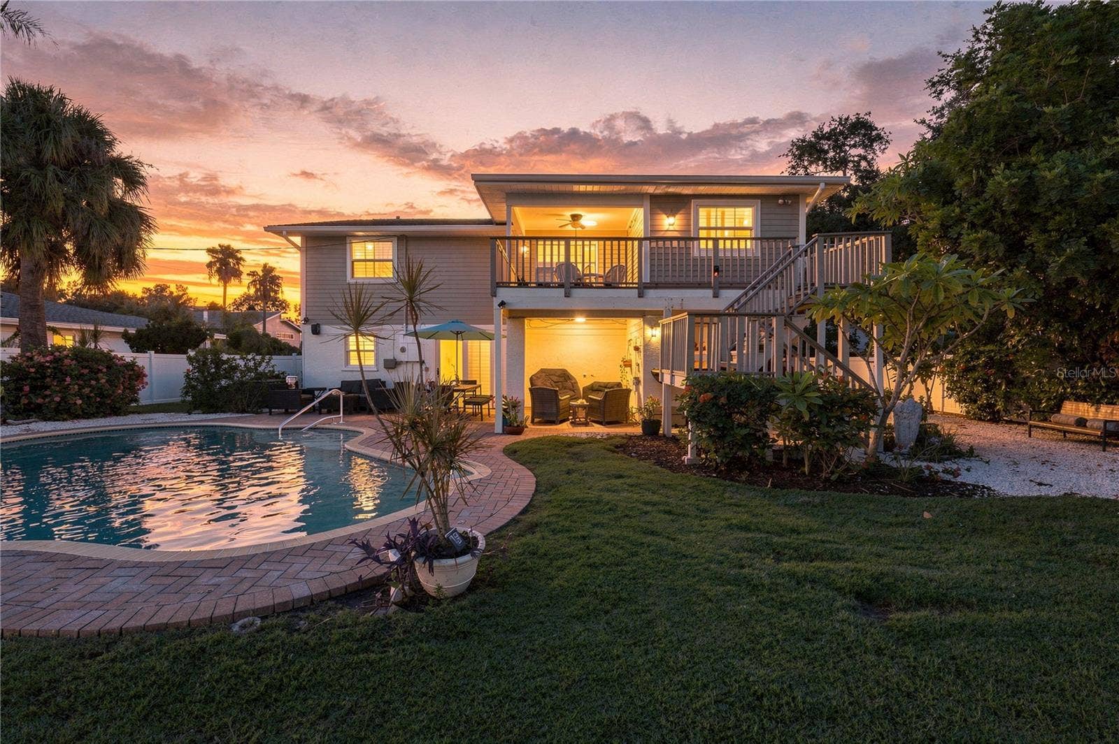 Imagine enjoying a sunset from your pool and this backyard!