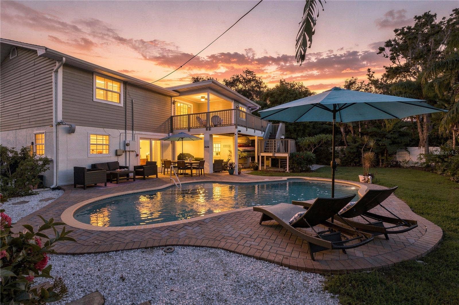 Imagine enjoying a sunset from your pool and this backyard!
