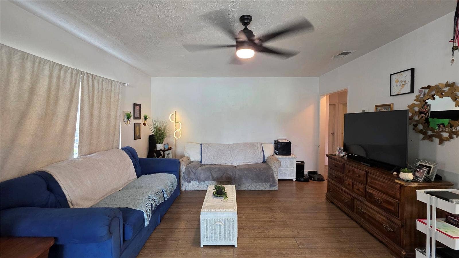 1702 26TH STREET W, Bradenton, FL 34205 Living Room with Ceiling Fan, Laminate Flooring, and Window overlooking Front Yard