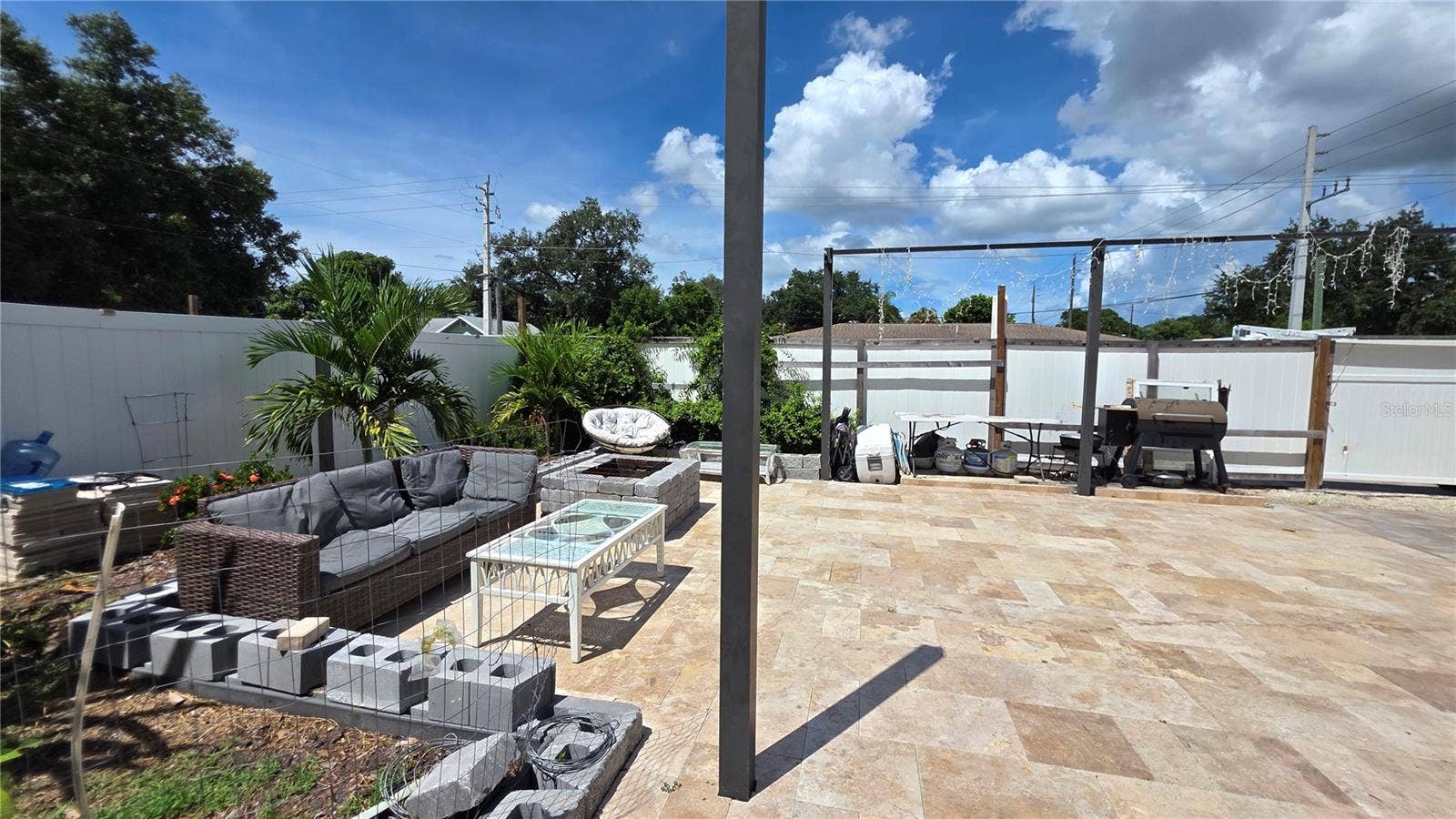 1702 26TH STREET W, Bradenton, FL 34205 Pavered/Tiled back patio area with vinyl fence partition