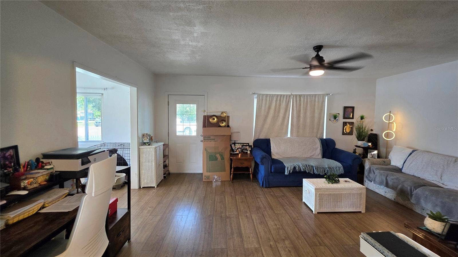 1702 26TH STREET W, Bradenton, FL 34205 Living Room with Ceiling Fan, Laminate Flooring, and Window overlooking Front Yard, Front Door Entry