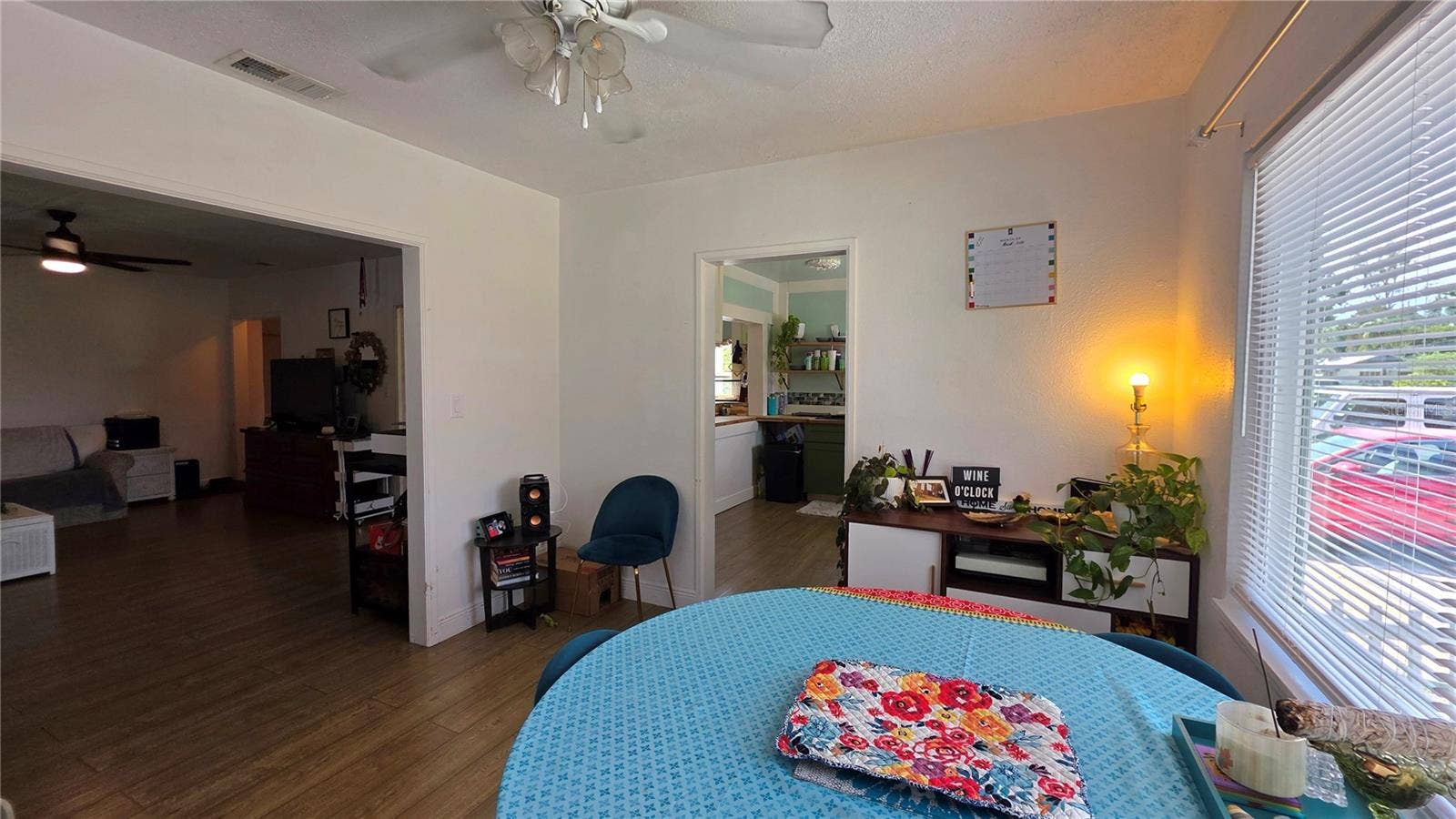 1702 26TH STREET W, Bradenton, FL 34205 Dining/Flex Room Adjacent to Livingf Room, with Ceiling Fan, Laminate Flooring, and Windows overlooking Side Yard