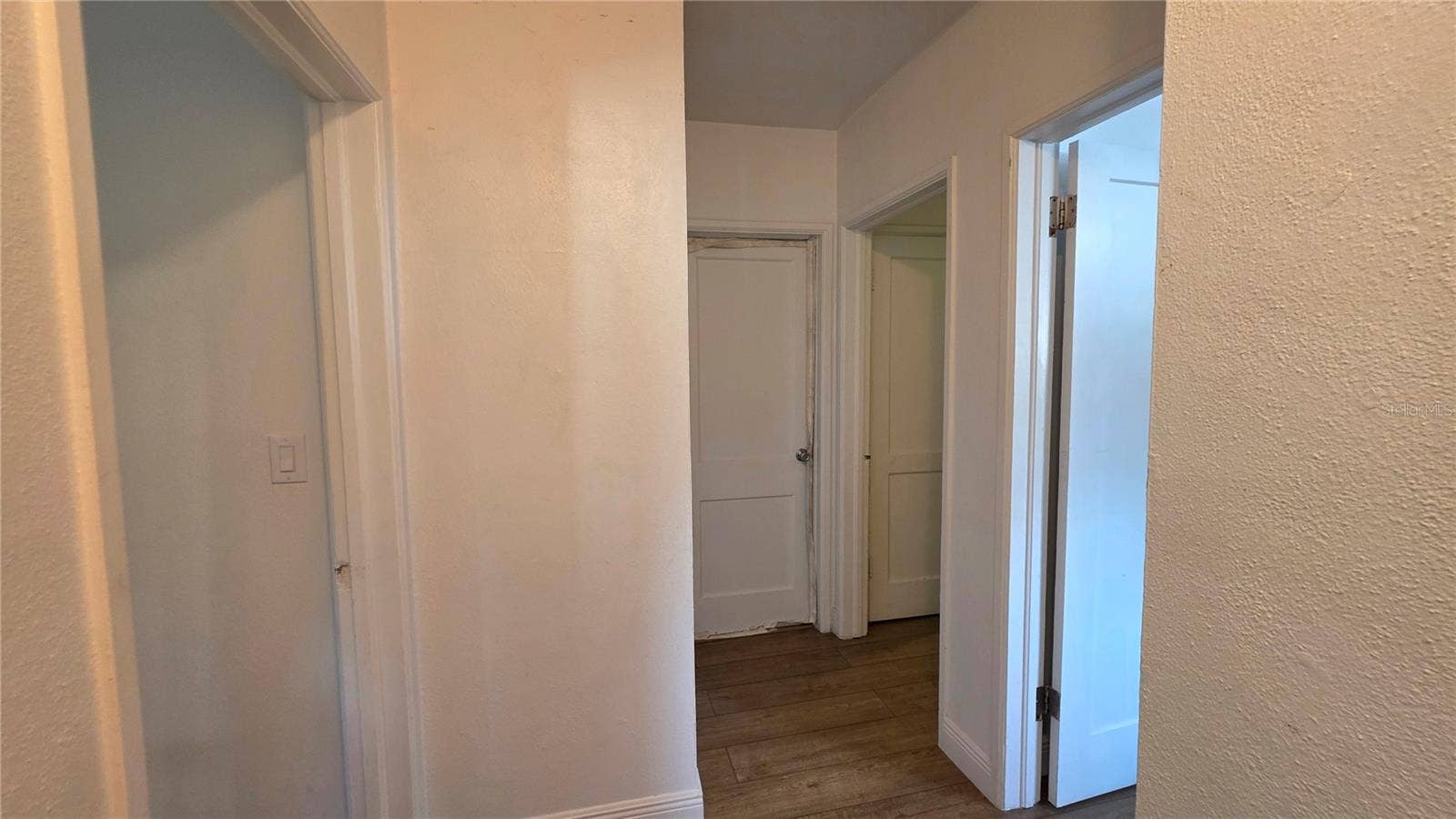 1702 26TH STREET W, Bradenton, FL 34205 Hallway and Doors to Primary, 2 Bedrooms, and Full Bathroom (non-functional)