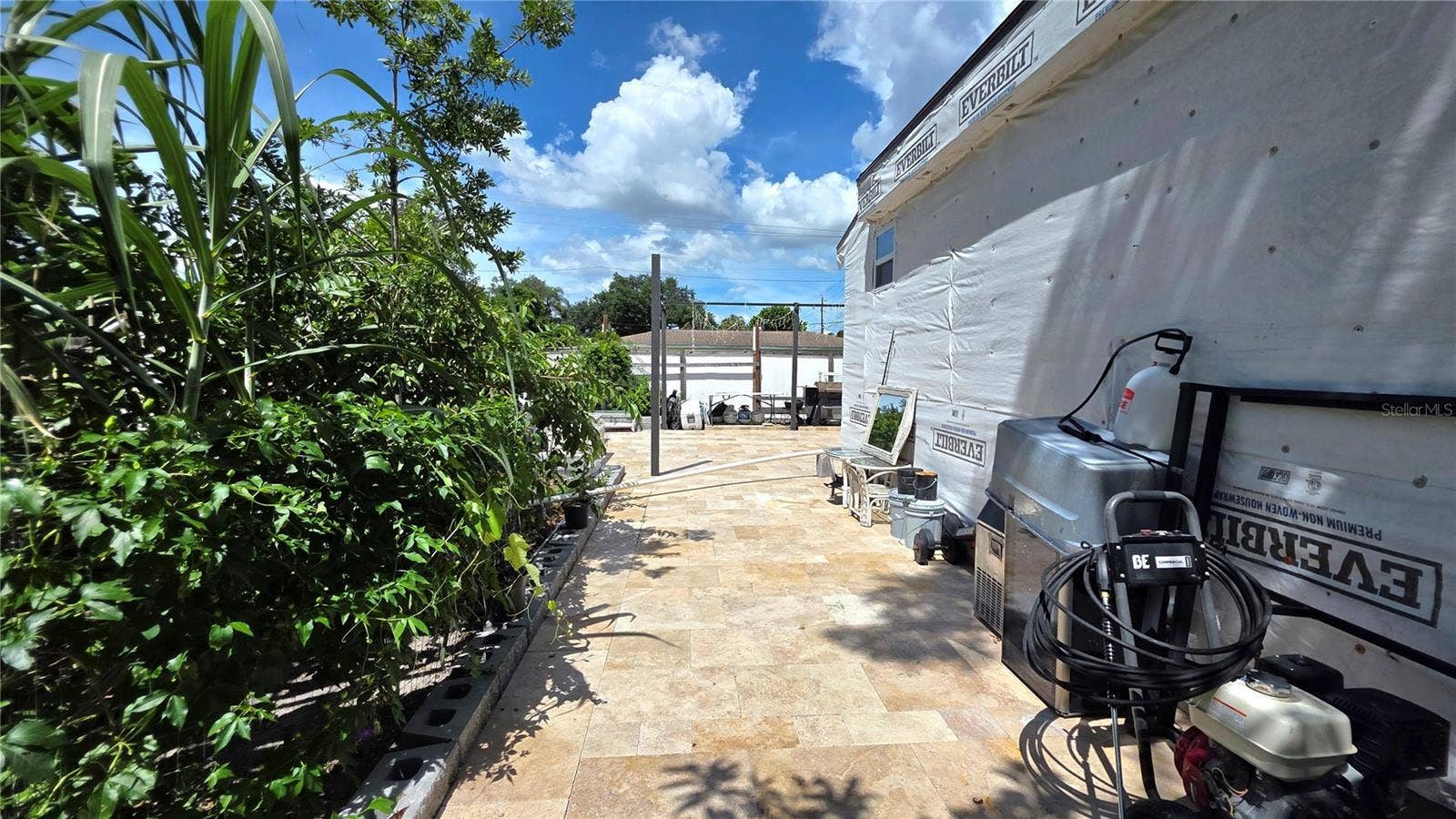 1702 26TH STREET W, Bradenton, FL 34205 View from Behine Home, Garden Area, Tiled/Pavered Back Patio. Note - Addition being added to home will need to be removed.
