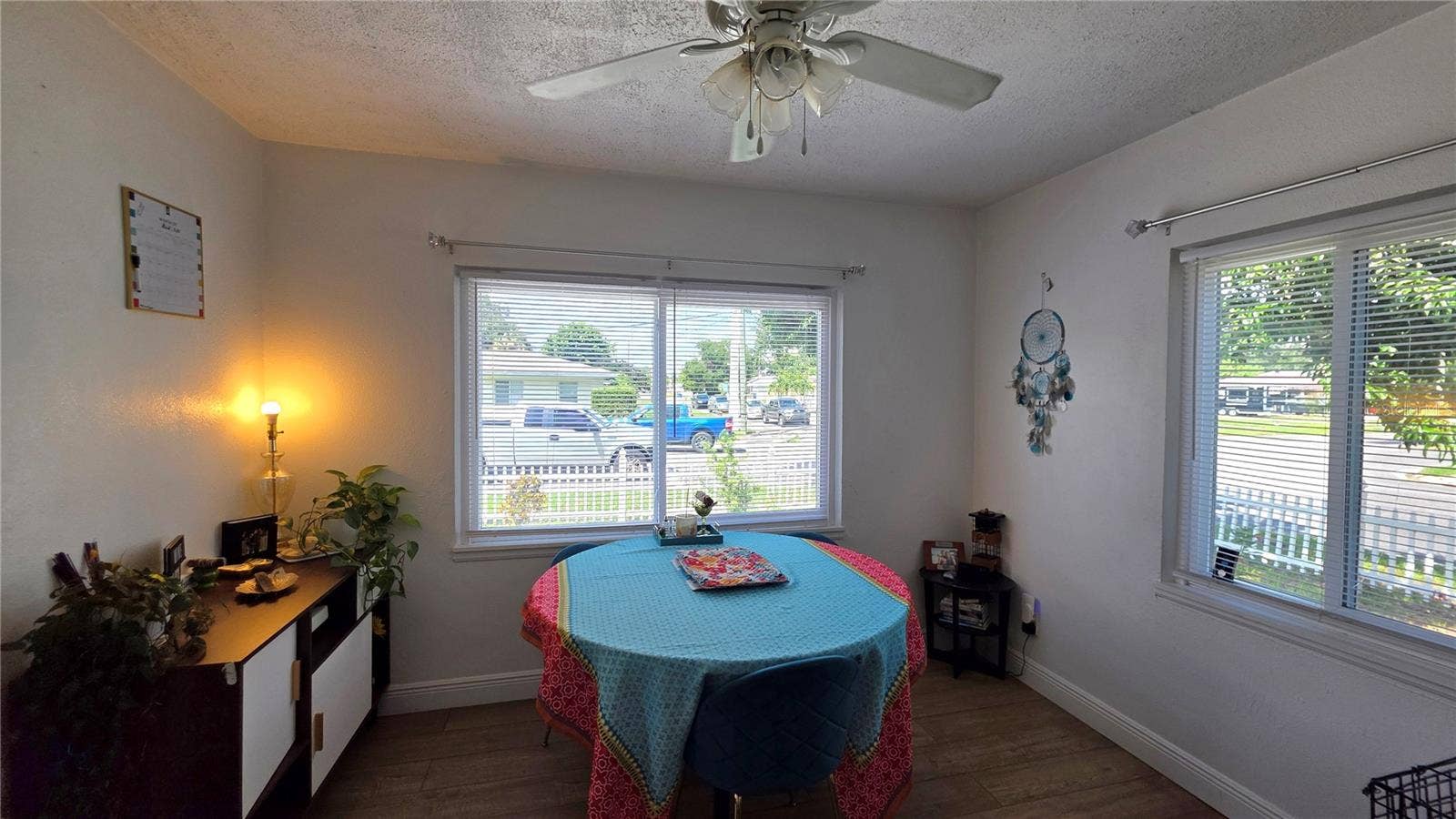 1702 26TH STREET W, Bradenton, FL 34205 Dining/Flex Room with Ceiling Fan, Laminate Flooring, and Windows overlooking Side Yard and Front Yard