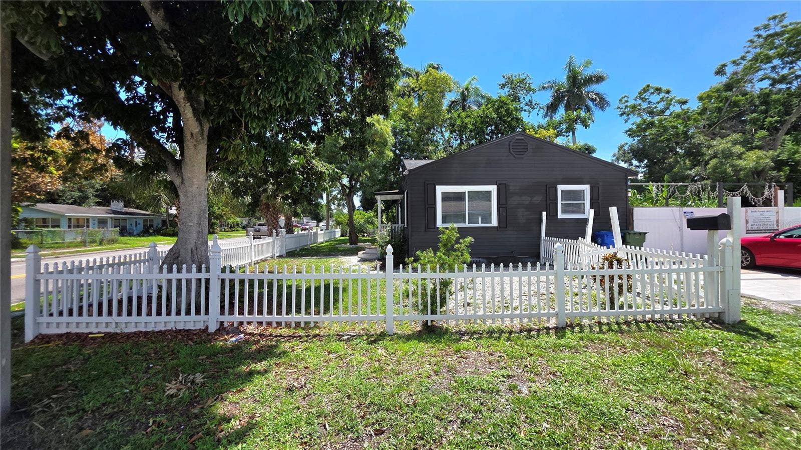 1702 26TH STREET W, Bradenton, FL 34205 Side Yard View, Fully Fenced, Driveway & Parking on Side of Home, Gates to Enter Backyard & Back Entrance