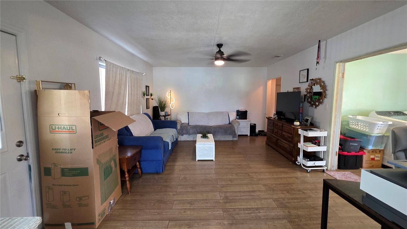 1702 26TH STREET W, Bradenton, FL 34205 Living Room with Ceiling Fan, Laminate Flooring, and Window overlooking Front Yard