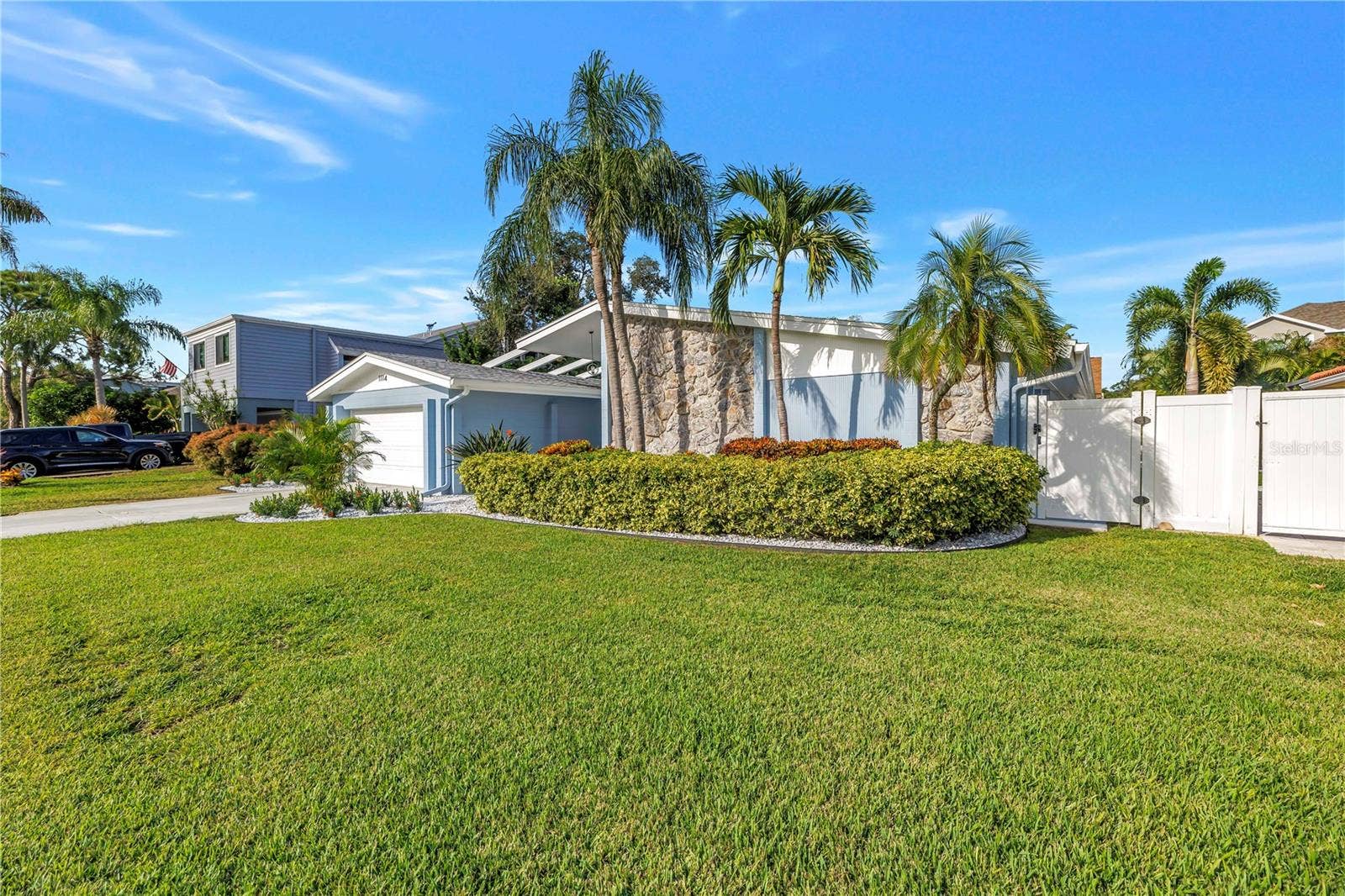 1114 2ND AVENUE S, Tierra Verde, FL 33715 Reclaimed water supplies irrigation for your tropical paradise! Vinyl PVC fence with two access gates on either side.