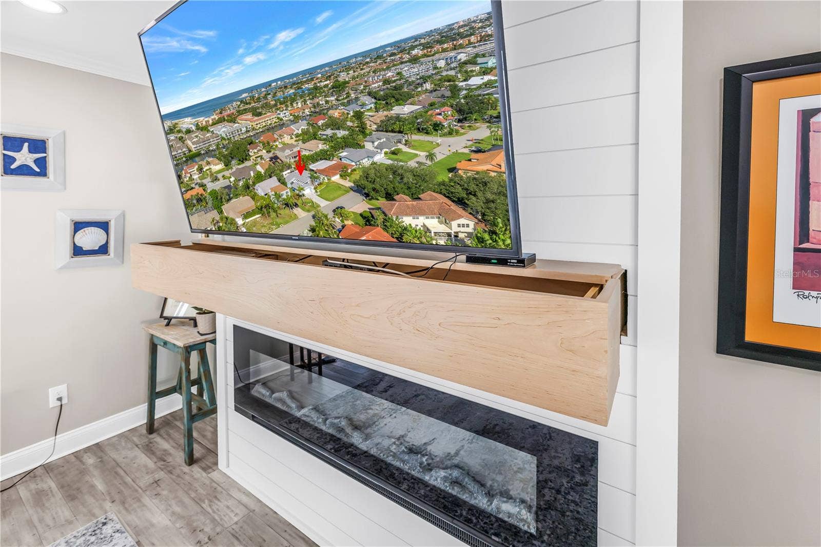 1114 2ND AVENUE S, Tierra Verde, FL 33715 Custom mantel is an A/V storage drawer over the electric fireplace.
