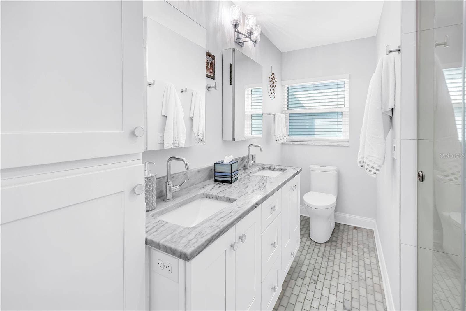 1114 2ND AVENUE S, Tierra Verde, FL 33715 Deep vanity drawers, linen closet and 2 Robern medicine cabinets with dual interior mirrors and electrical outlets.