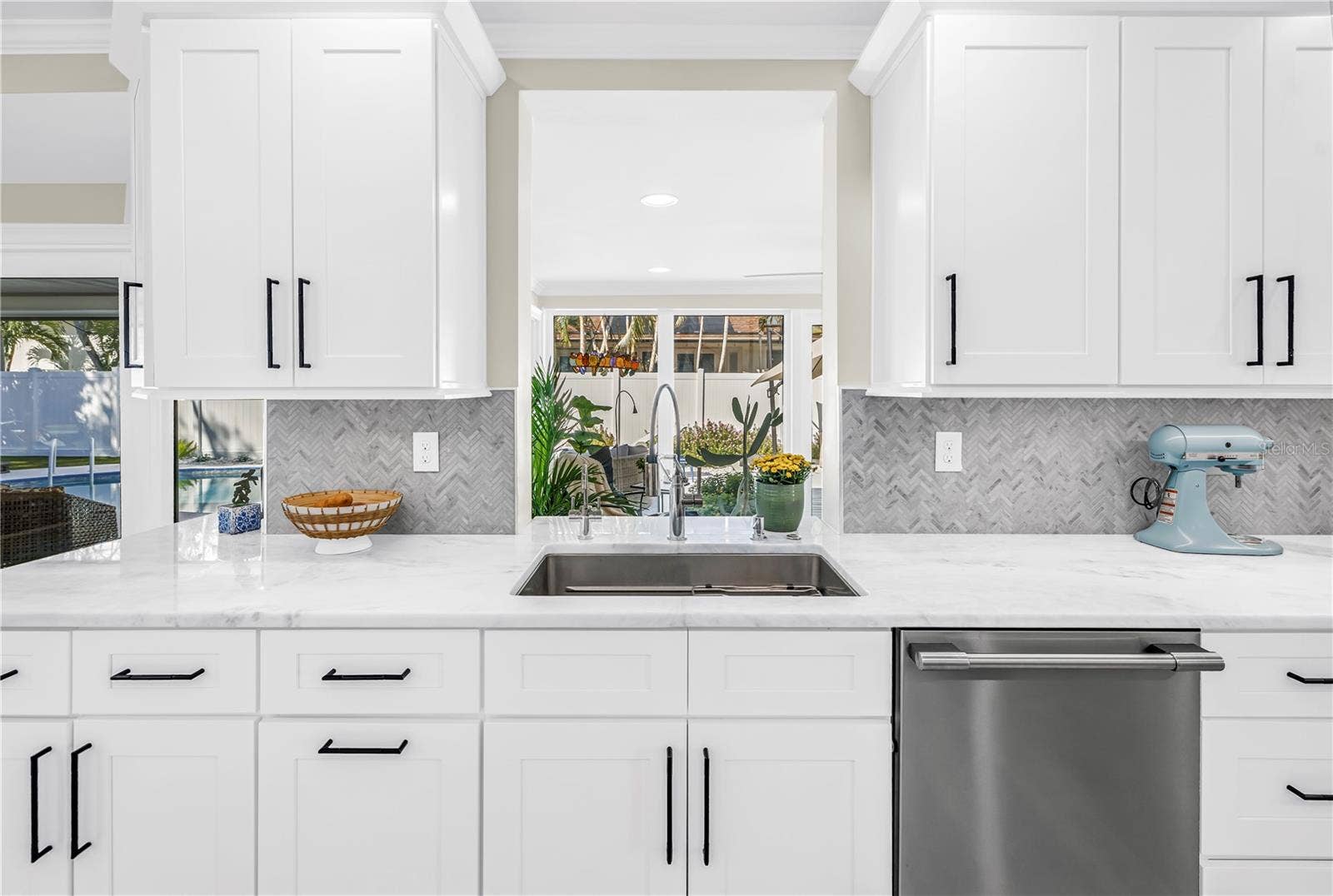 1114 2ND AVENUE S, Tierra Verde, FL 33715 Extra long stainless steel sink with drying shelf hosts instant hot water and filtered cold water. (Pass through to Solarium/ Florida Room)