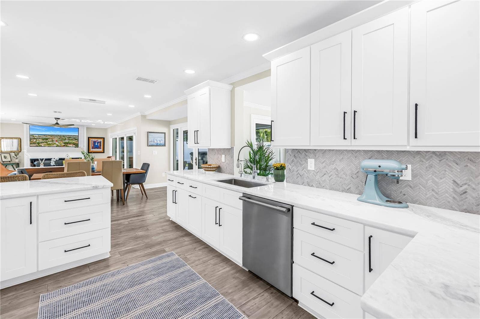 1114 2ND AVENUE S, Tierra Verde, FL 33715 White Shaker cabinetry with upper and lower molding details and under counter lighting.