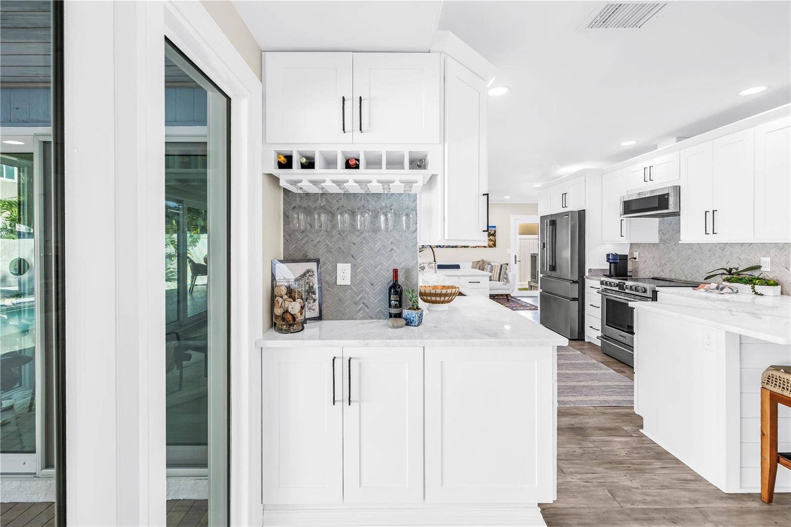 1114 2ND AVENUE S, Tierra Verde, FL 33715 Custom built-in bar area with herringbone tile backsplash.