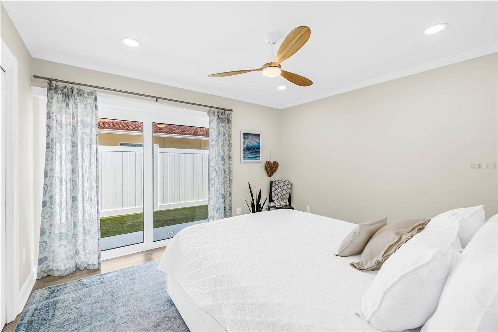 1114 2ND AVENUE S, Tierra Verde, FL 33715 Second bedroom patio to side yard (also has Garrison flood system for sliders).
