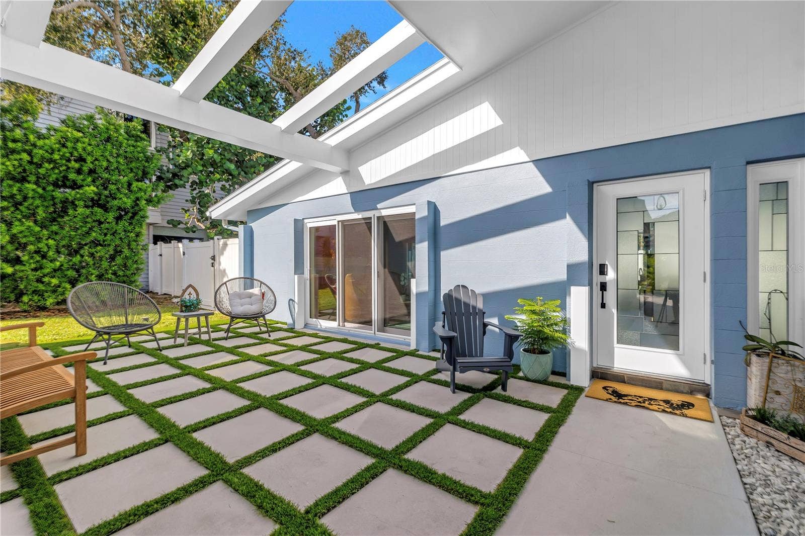 1114 2ND AVENUE S, Tierra Verde, FL 33715 Mid century modern architecture weclomes you and guests in your front courtyard.