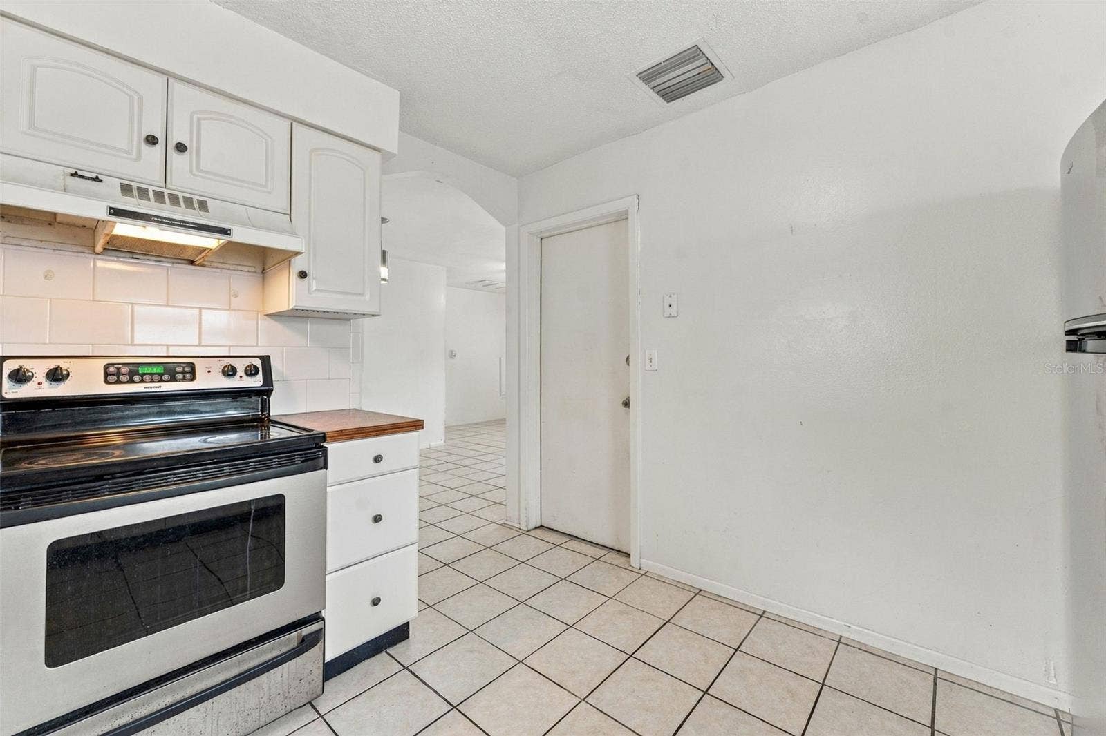 7303 RIVERBANK DRIVE, New Port Richey, FL 34655 Kitchen with White Cabinetry