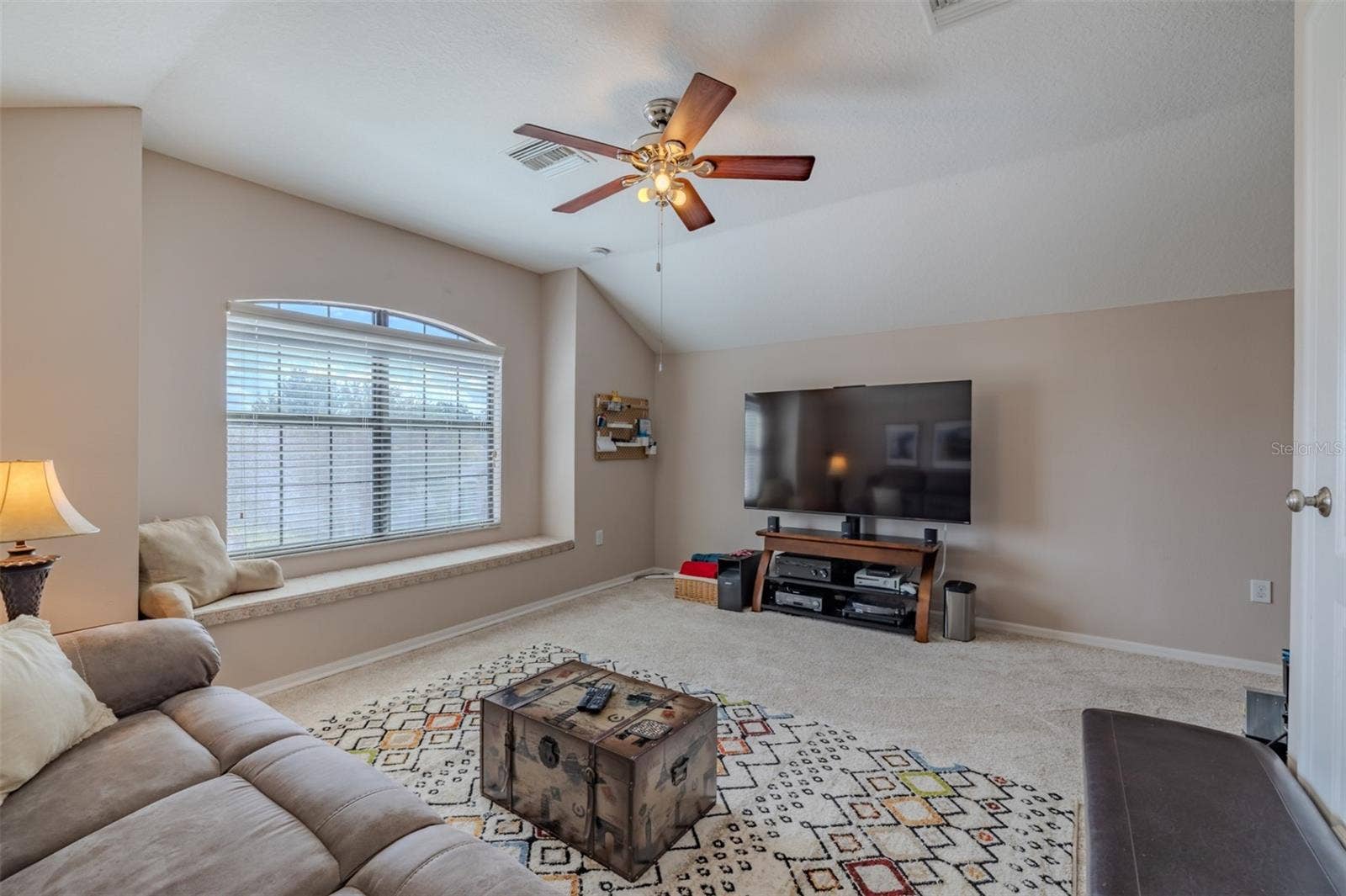 9123 RAES CREEK PLACE, Palmetto, FL 34221 Awesome bonus room with lovely window seat. Bonus room sofa and TV stand convey.