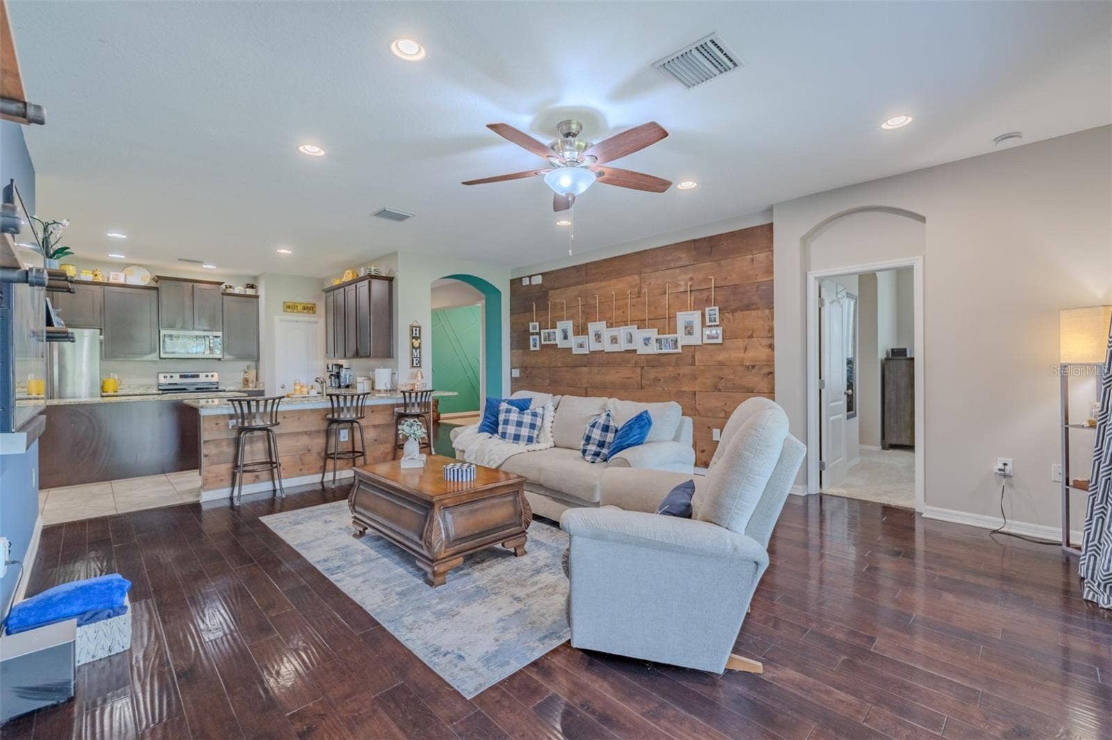 9123 RAES CREEK PLACE, Palmetto, FL 34221 Family room with kitchen view