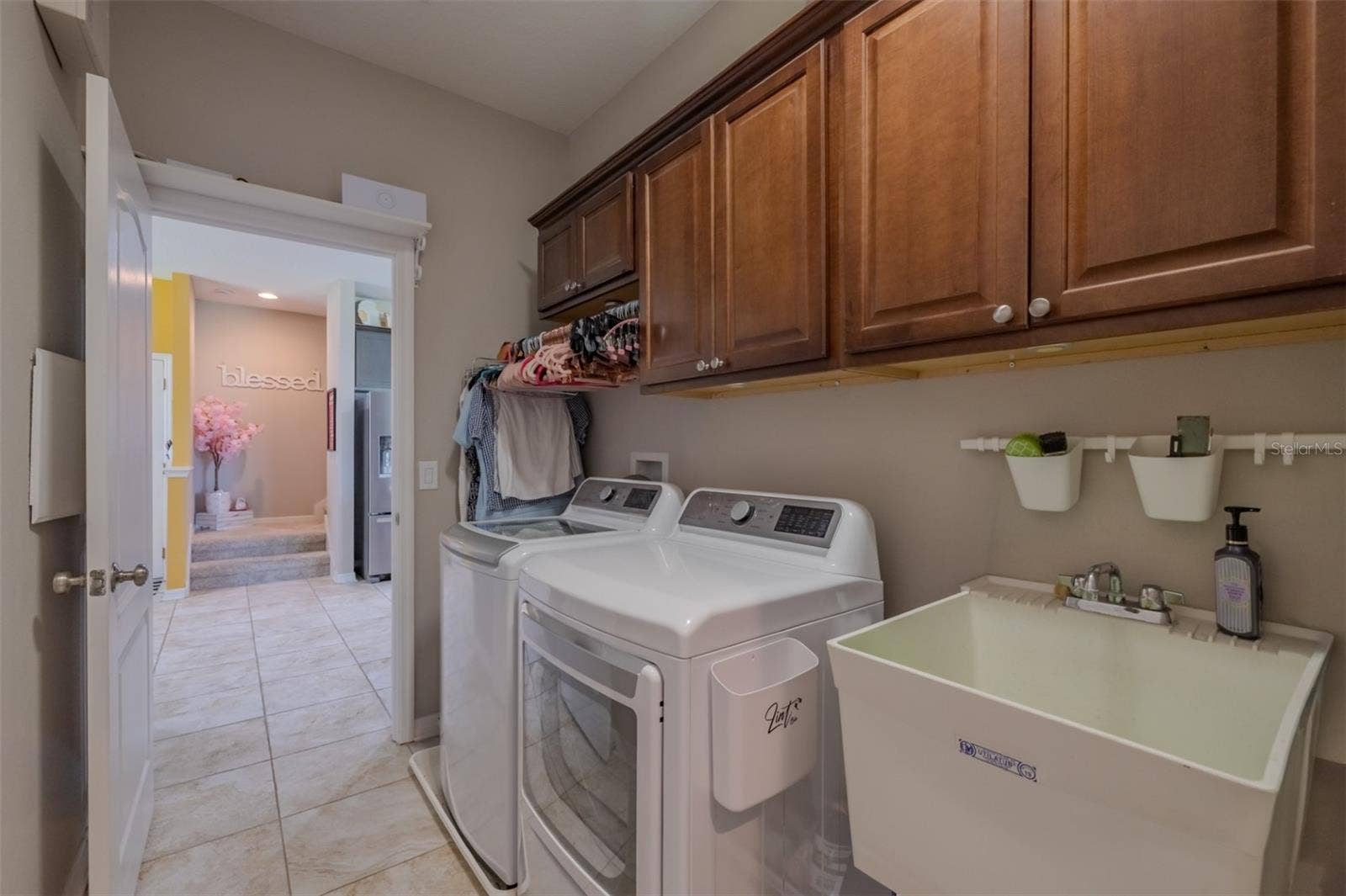 9123 RAES CREEK PLACE, Palmetto, FL 34221 Laundry room conviently located with a wash sink and cabinets. Washer & dryer do not convey