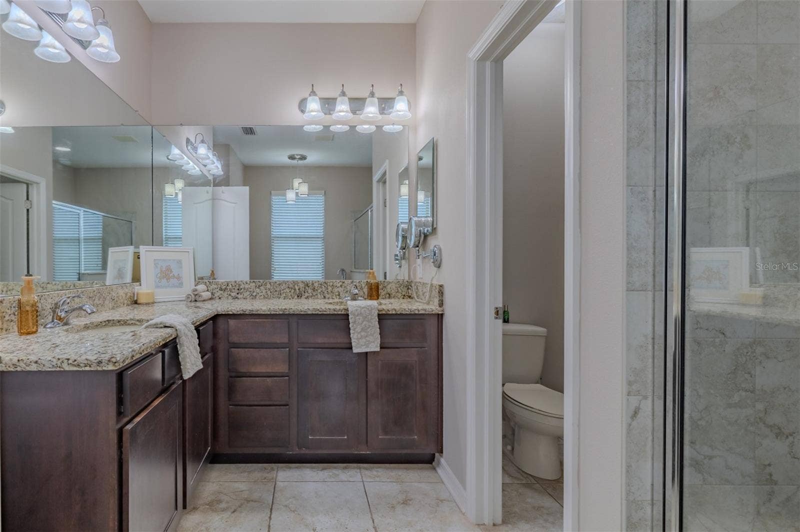 9123 RAES CREEK PLACE, Palmetto, FL 34221 Primary bathroom with his & hers sinks with a water closet