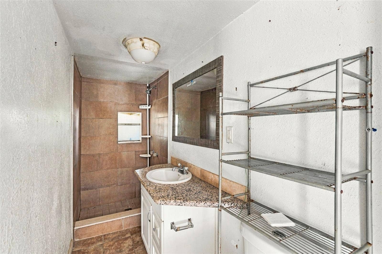 Rear residence  bathroom with vanity and walk-in shower