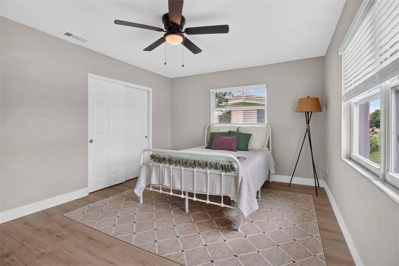 GOOD SIZED PRIMARY BEDROOM WITH BUILT IN CLOSET AND NEW CEILING FAN