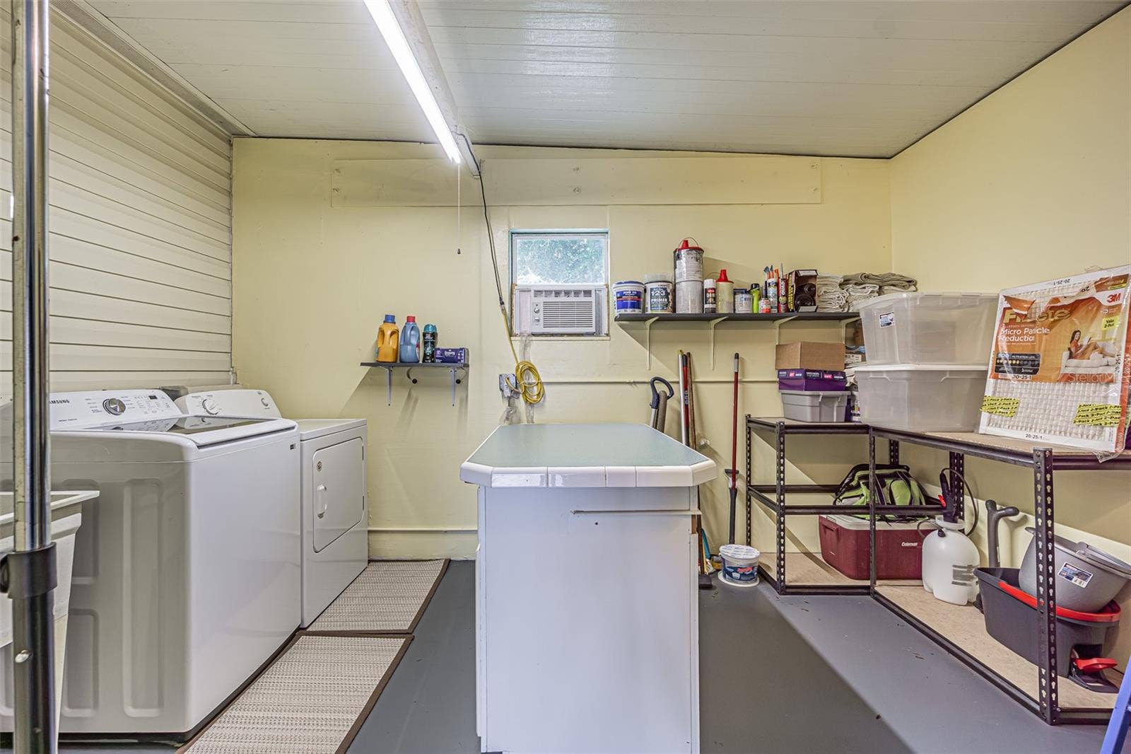 37232 NEUKOM AVENUE, Zephyrhills, FL 33541 AWESOME laundry area with AC, utiltiy sink and folding center island for storage in shed
