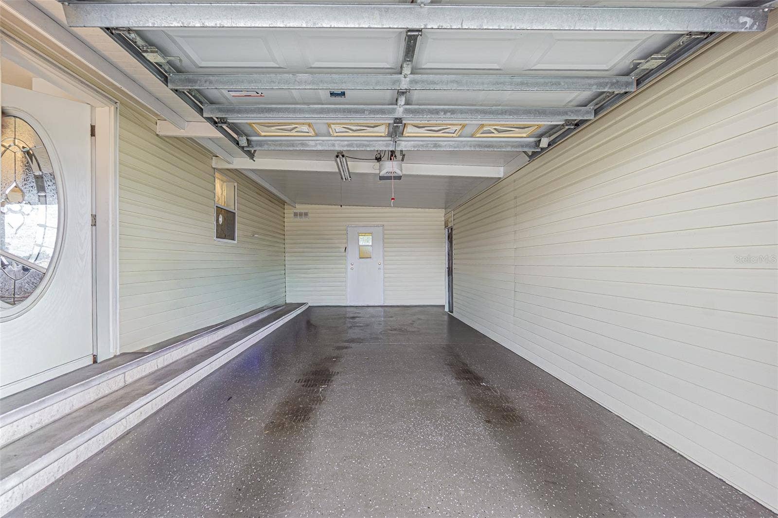 37232 NEUKOM AVENUE, Zephyrhills, FL 33541 One car garage with epoxy floor finish and shed access