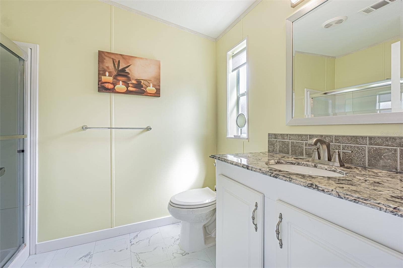 37232 NEUKOM AVENUE, Zephyrhills, FL 33541 Granite countertops and updated floors in this sleek bath