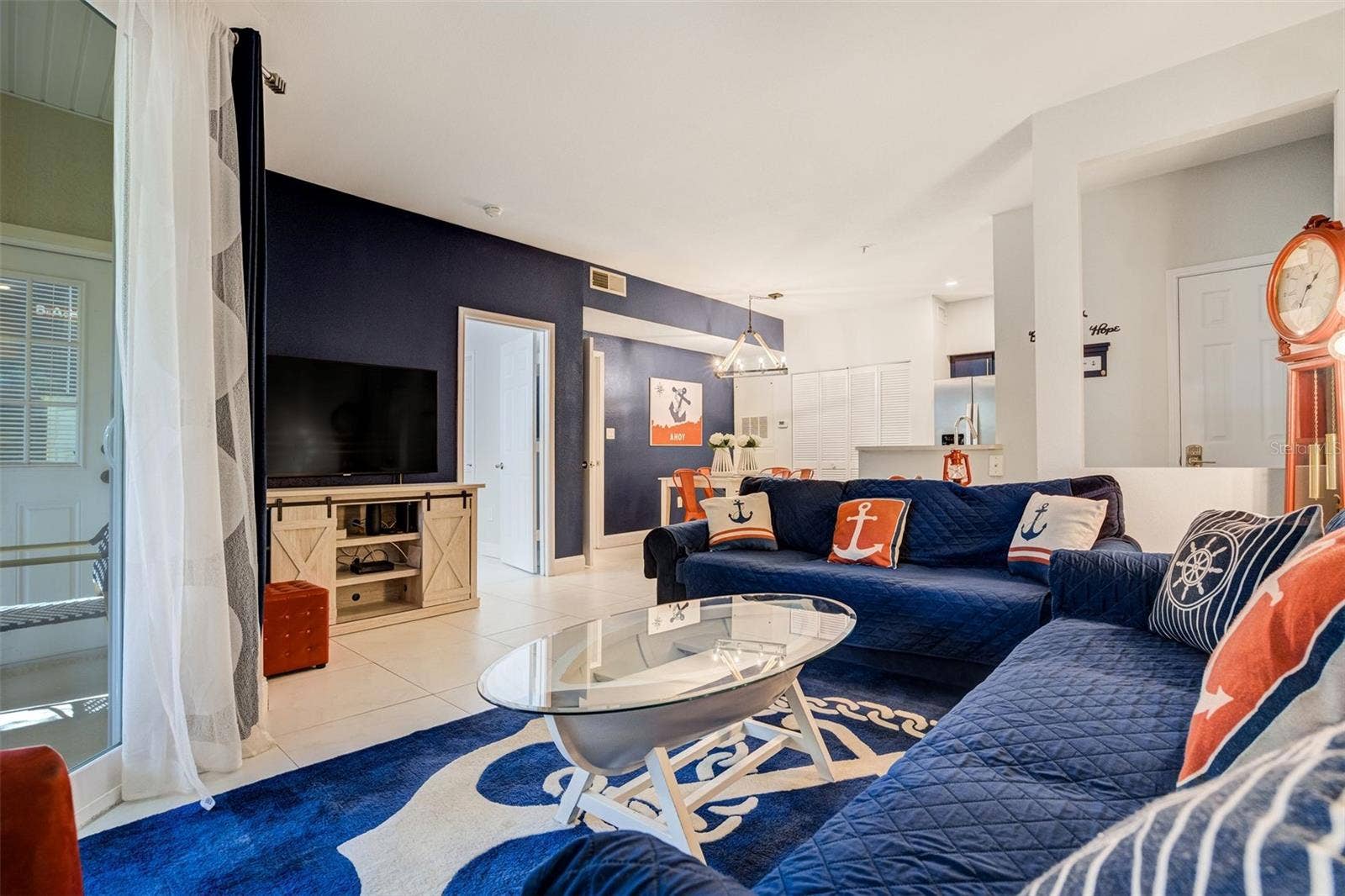1230 S MISSOURI AVENUE, #704, Clearwater, FL 33756 Living room/dining room combo with impact slider to covered patio