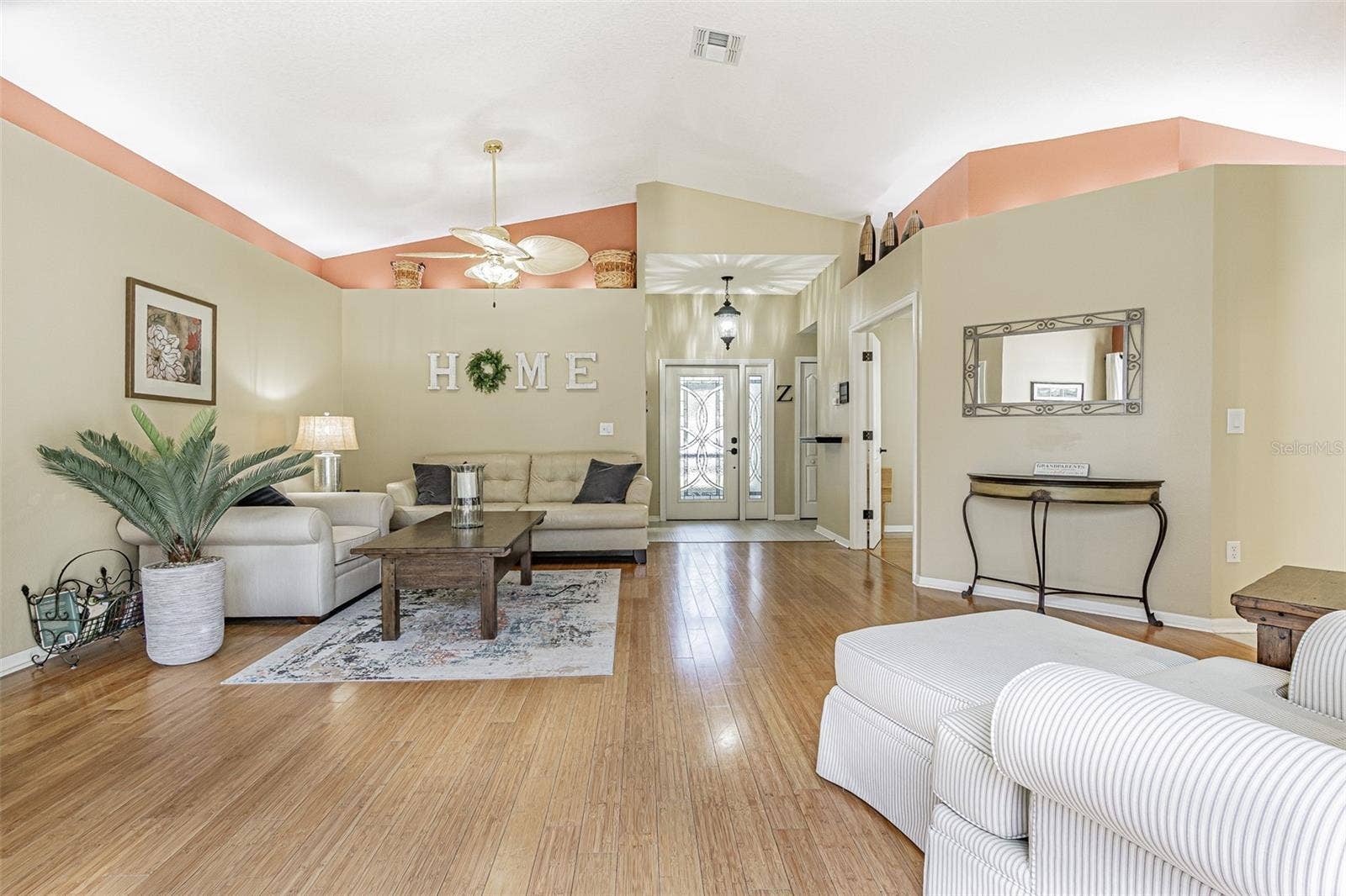 Cathedral ceilings, plant shelves and leaded glass entry door for a light, bright GREAT ROOM!