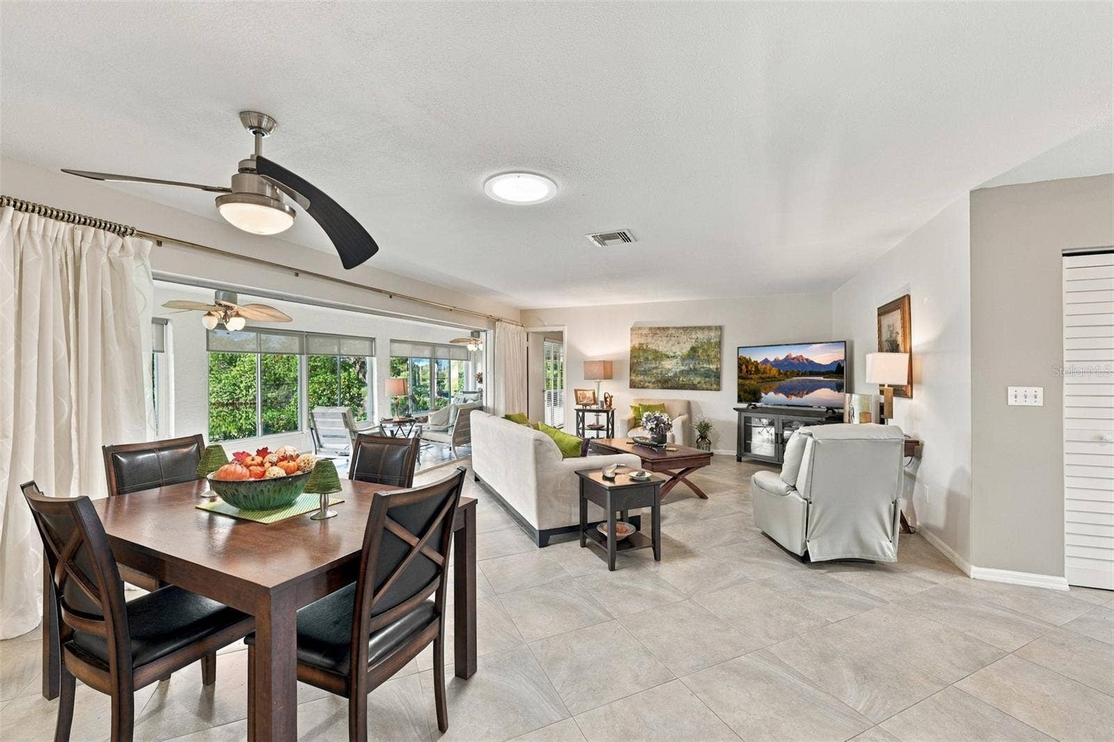 211 STONEHAM DRIVE, Sun City Center, FL 33573 Beautiful tile flooring floats through out the open floor plan of the home, in a modern diagonal pattern. A large wall of windows brings in light, mother nature and a world of tranquility and peace.