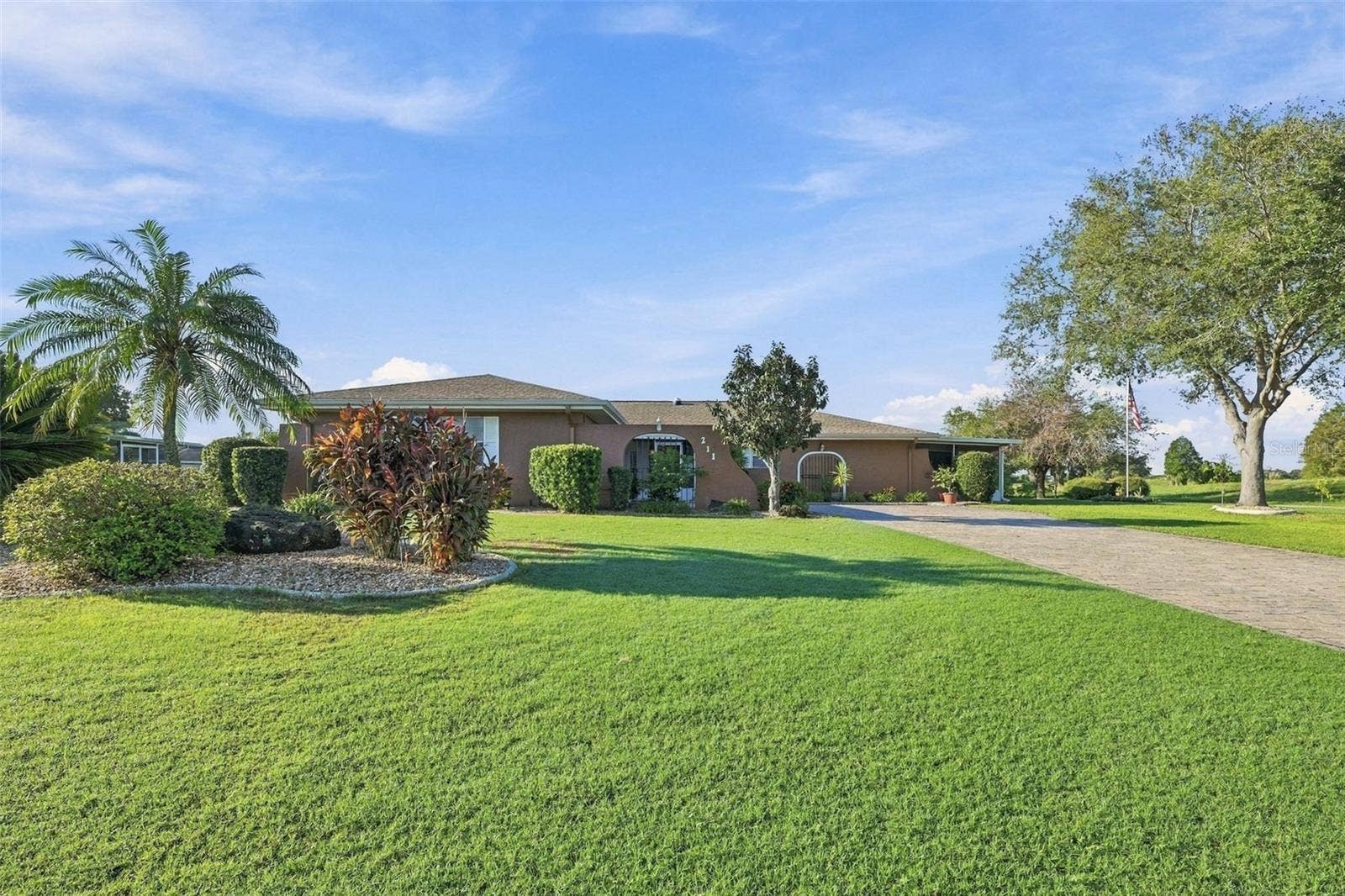 211 STONEHAM DRIVE, Sun City Center, FL 33573 This lot is almost 1/2 acres with custom curbing and easy maintenance plantings.