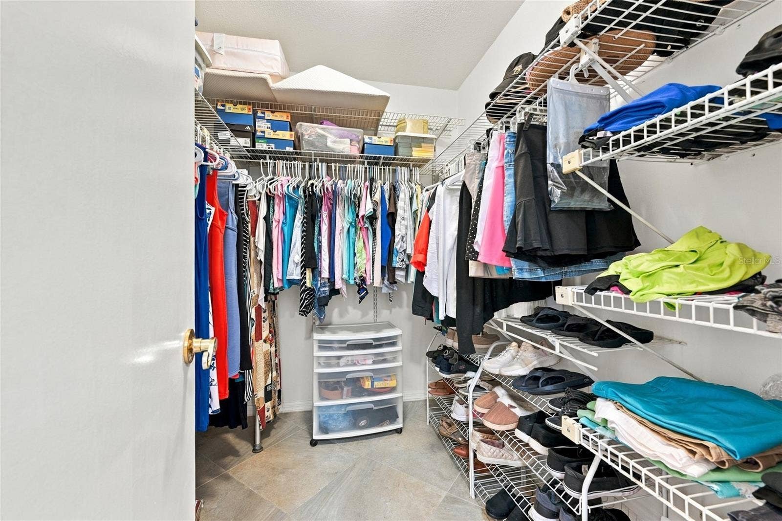 211 STONEHAM DRIVE, Sun City Center, FL 33573 Large walk-in closet with lots of shelving for storage.