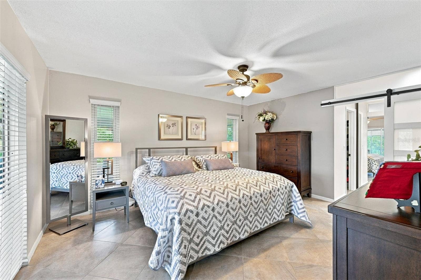 211 STONEHAM DRIVE, Sun City Center, FL 33573 The primary bedroom has an ensuite bathroom for maximum privacy and a walk-in closet.
